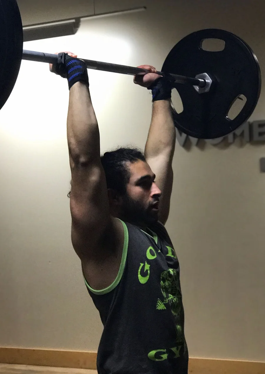 Saugat Ghimire lifting a barbell overhead